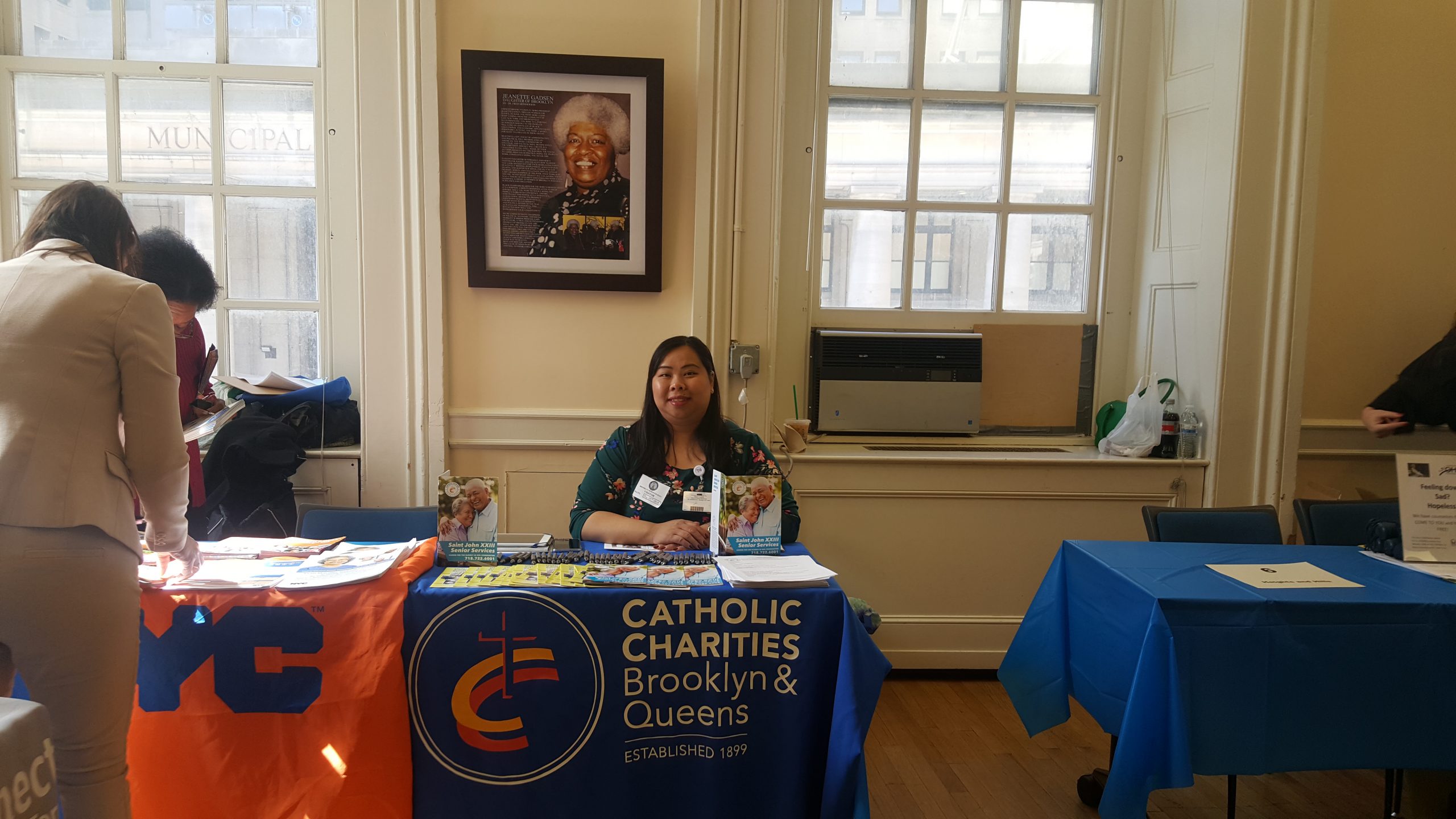 a member of catholic charities sharing wealth of information for senior citizens at annual older americans month 2019 resource fair