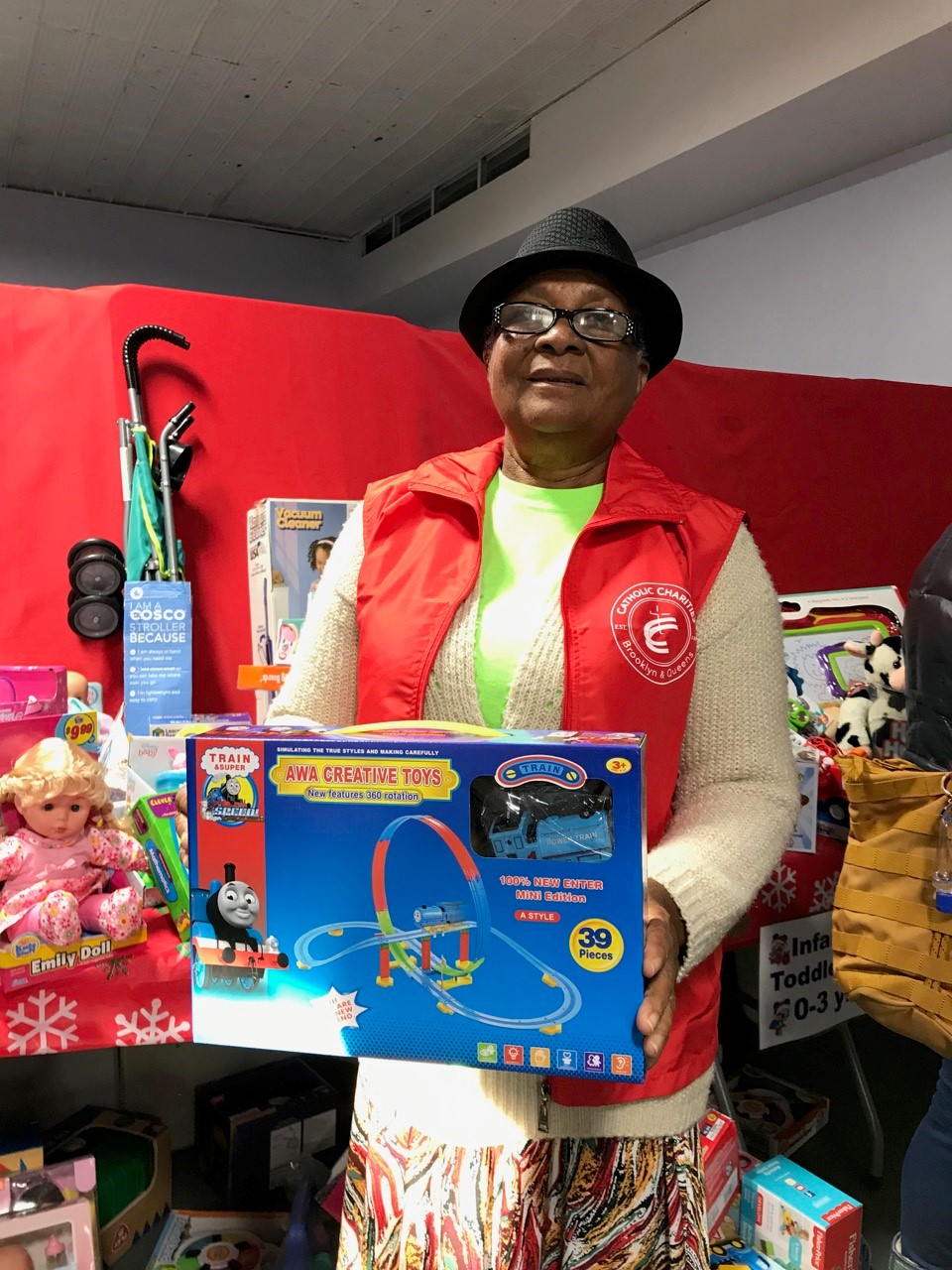 a woman presenting a toy from the toy drive event