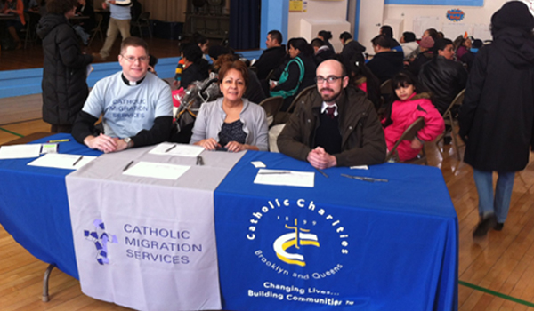 catholic charities booth and participants assisting those affected by hurricane sandy
