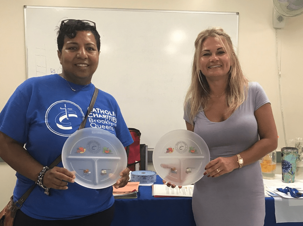 Women showing their portion plate and chart to help with meal planning