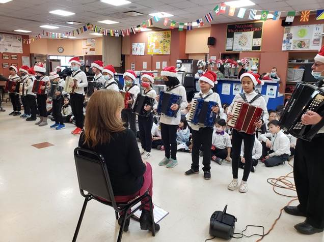 Students of PS 203 performing musical renditions for our older adults.