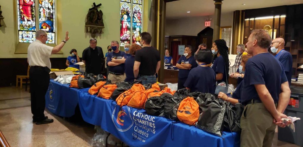 Msgr. Alfred P. LoPinto, President and CEO of Catholic Charities Brooklyn and Queens offers a prayer and words of encouragement to staff and volunteers before an information session and lunch for new arrivals seeking asylum on Monday, August 29, 2022 at St. Charles Borromeo Roman Catholic Church in Brooklyn Heights. (Photo: Catholic Charities Brooklyn and Queens)