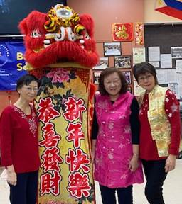 Bayside Older Adult Center members dressed up and posed with Lunar New Year prop.