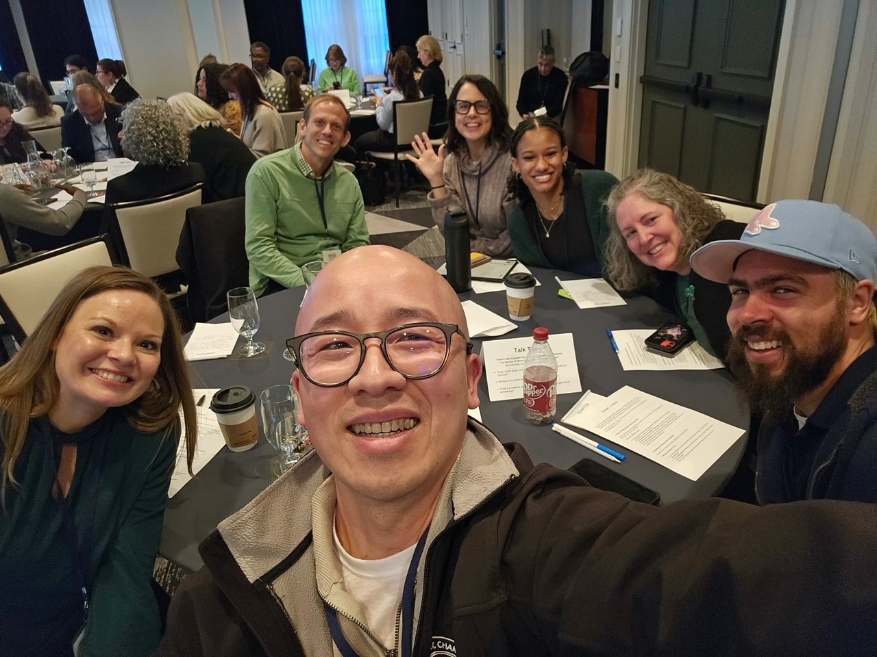 catholic charities staff members sitting at a round table at the conference