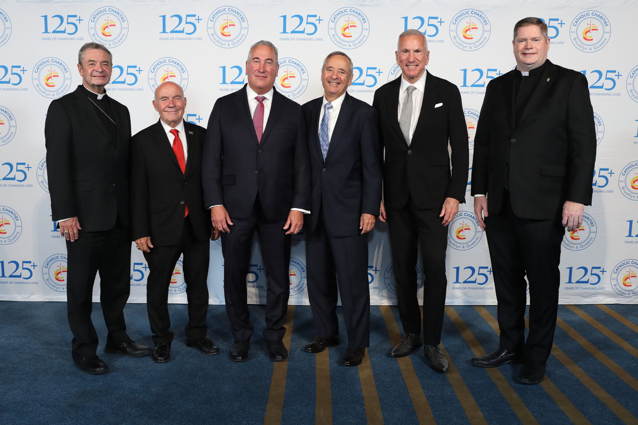 2026 Bishop's Humanitarian Dinner with From the left: Bishop Robert J. Brennan, Martin Sosa, Oluwatoyin (Toyin) Afolayan, Glenn Rosa, and Father Patrick J. Keating. (Photo credit: Jose Reyes Photography)