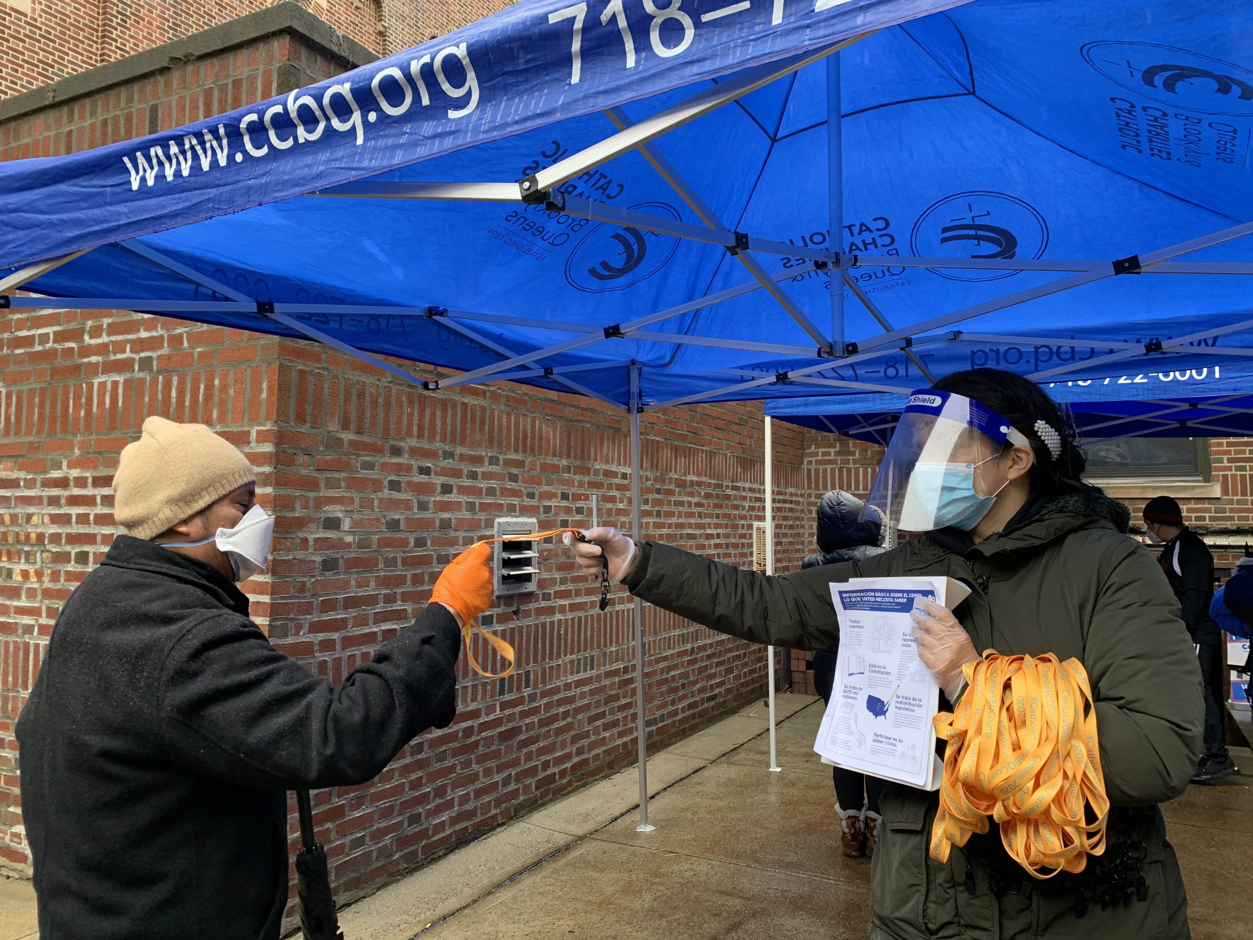 catholic charities staff member distributing information about the 2020 census in the streets of new york city