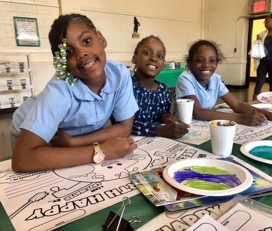 children smiling and celebrating earth day 2019