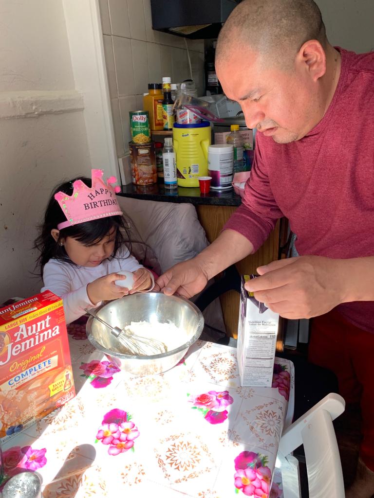 a dad and his early childhood daughter Cooking