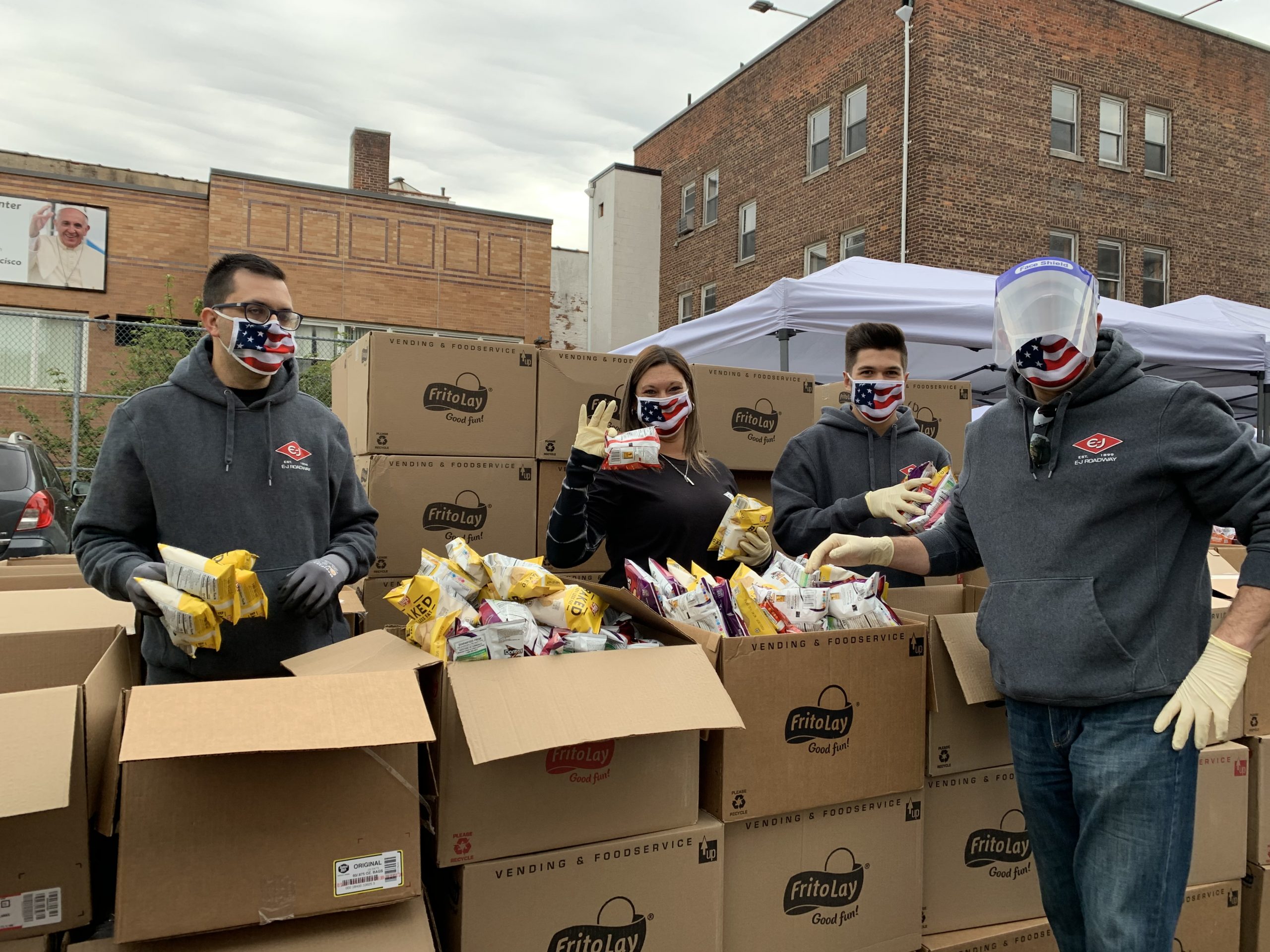 catholic charities staff members distributing food at the emergency food pop up