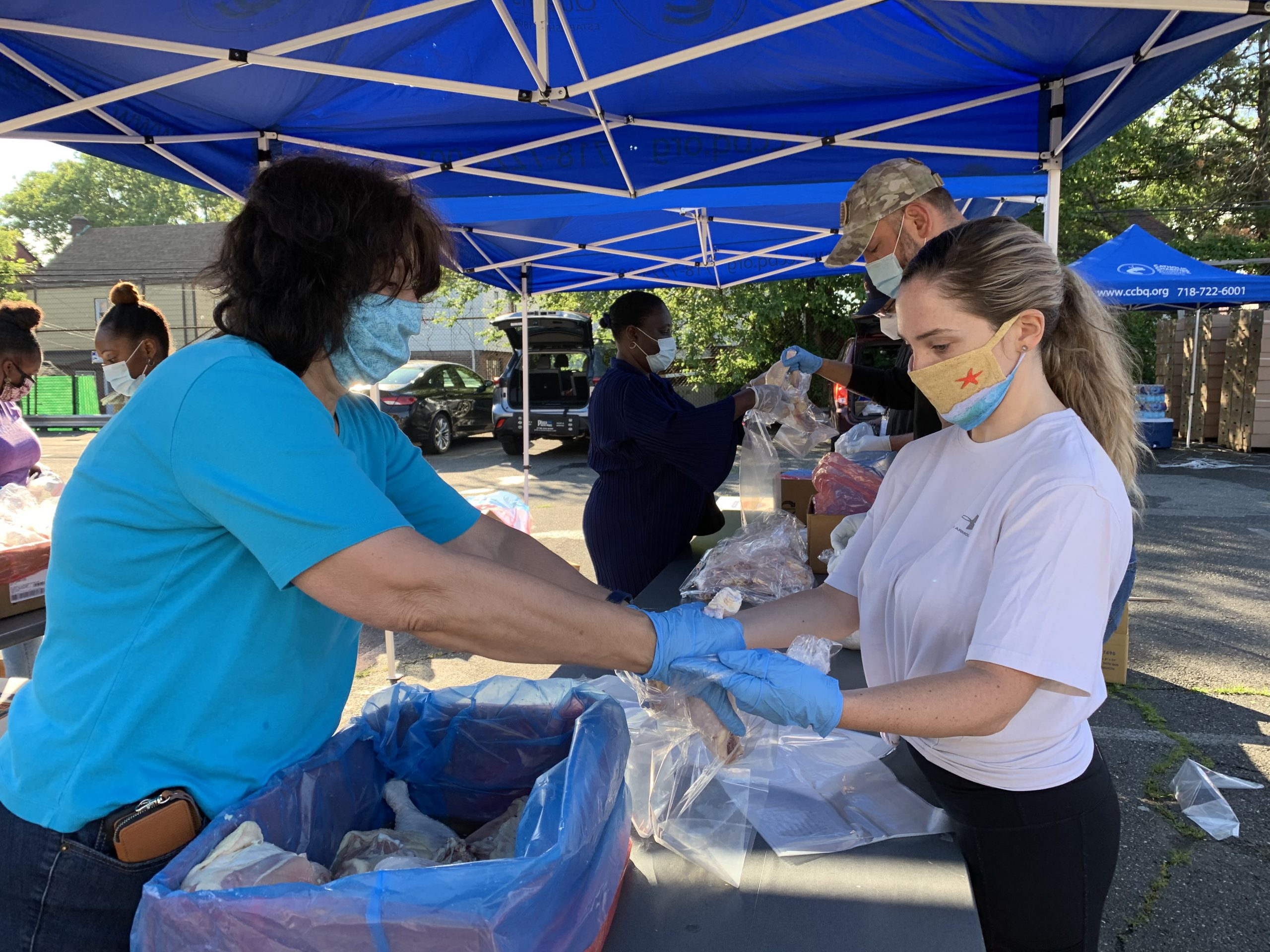 catholic charities staff members distributing food at an emergency pop up event