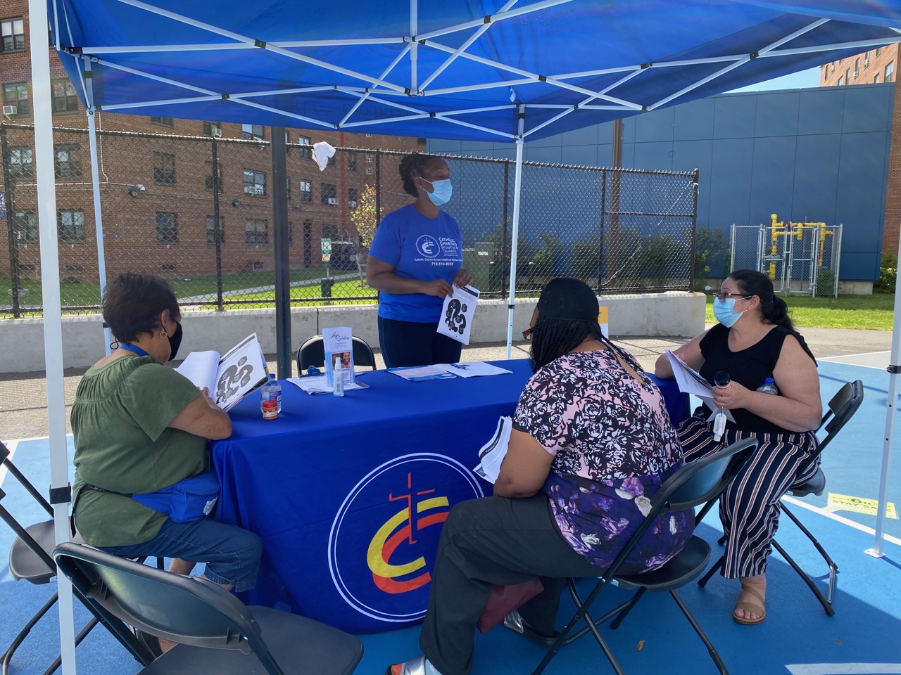 participants gathering information at the health and wellness event to keep our Community Safe During Summer Months