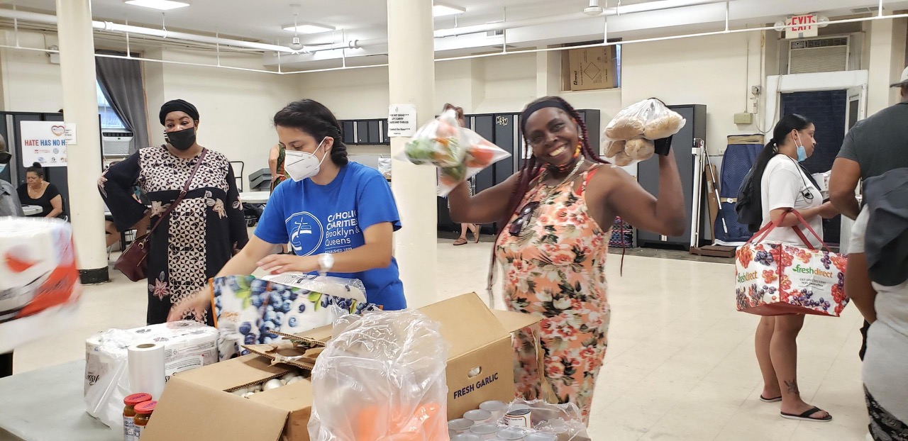 group of women being served at a food bank event for Feed Hungry New Yorkers