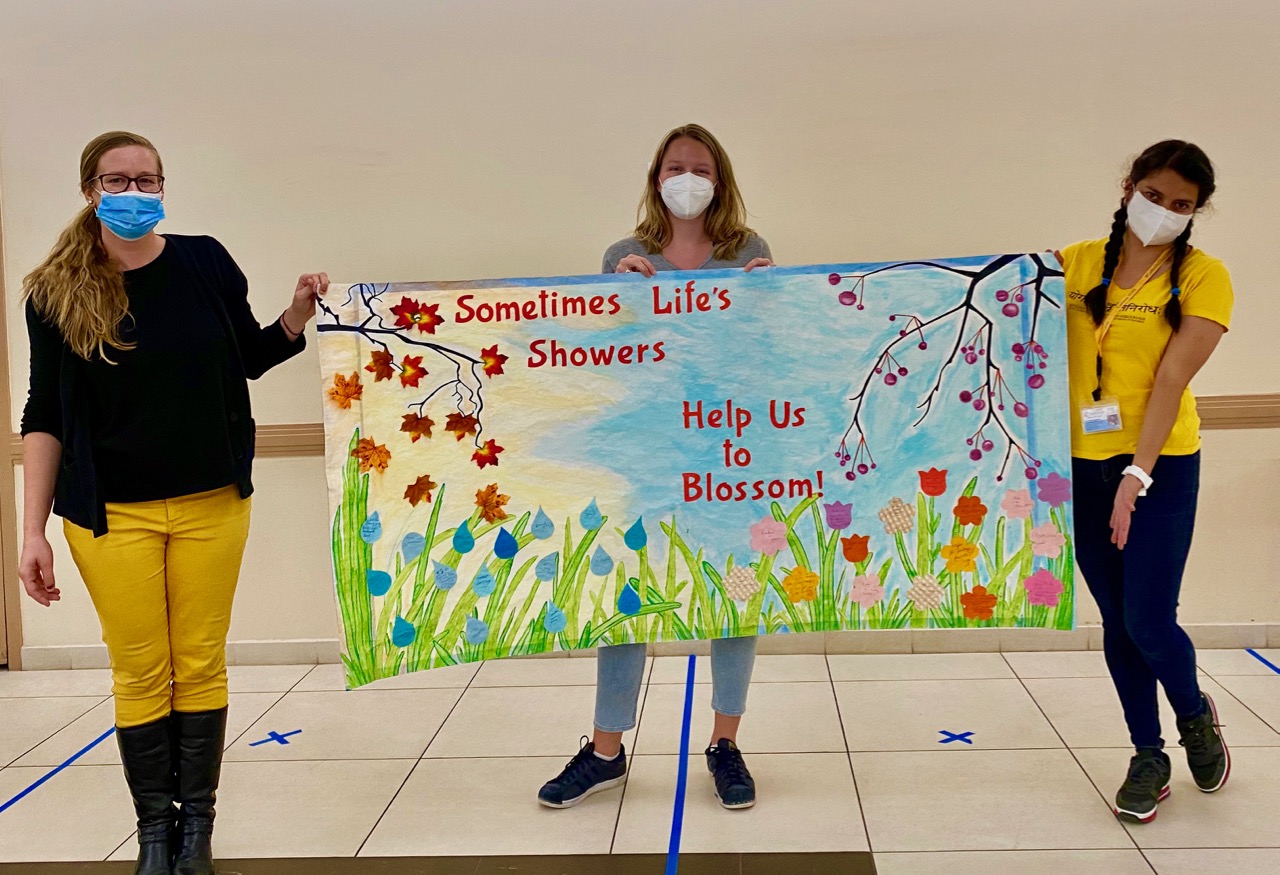 participants of our health and wellness program who crafted an art piece written Sometimes life's showers help us blossom is a way of Hope and Happiness Despite COVID-19