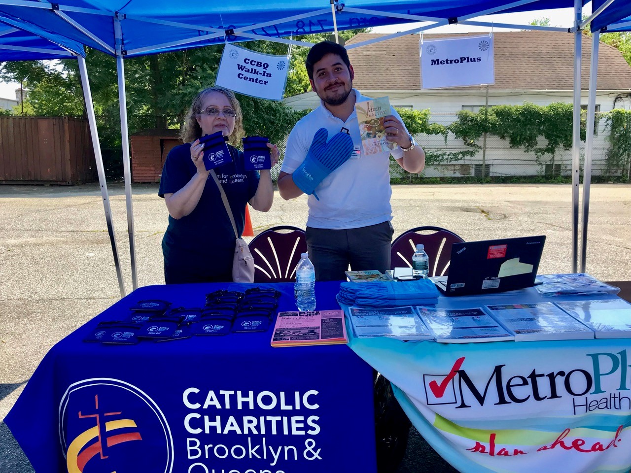 Catholic charities members at an outdoor fun event distributing information and services