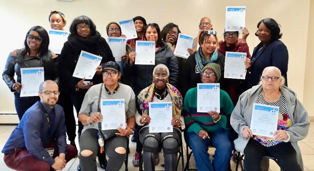 participants of the mental health first aid training program holding their completion certificate