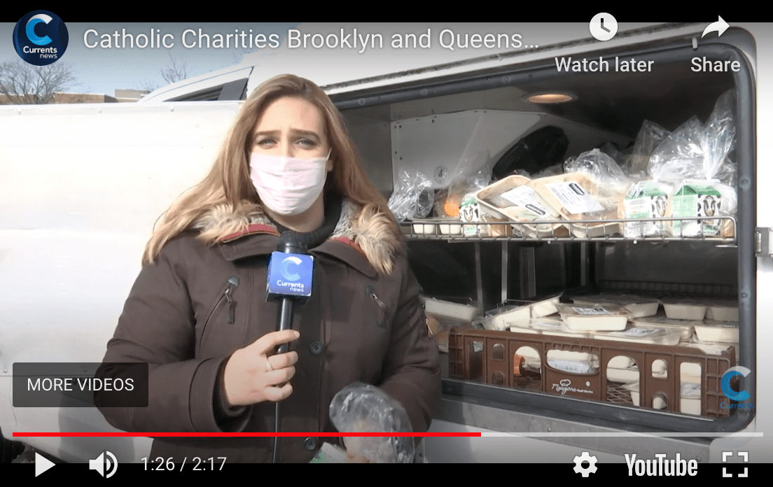 screenshot of a reporter showcasing catholic charities mobile unit with food for the homebound seniors during the pandemic
