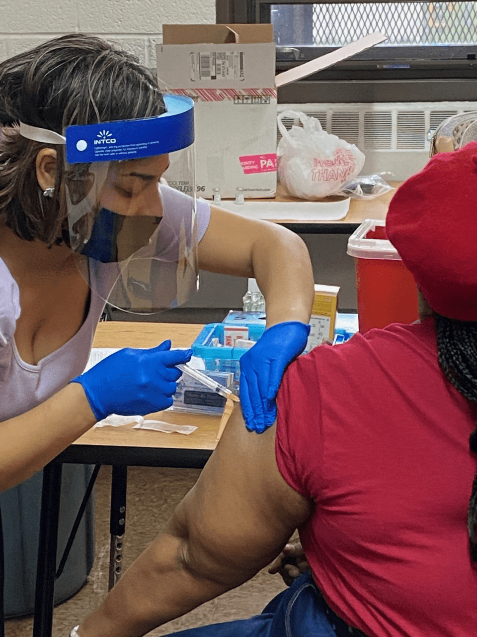 a health care professional providing a vaccination shot for covid-19