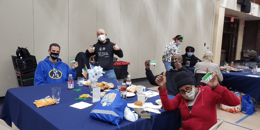homeless community smiling at the Catholic charities brooklyn and queens during St patrick's day