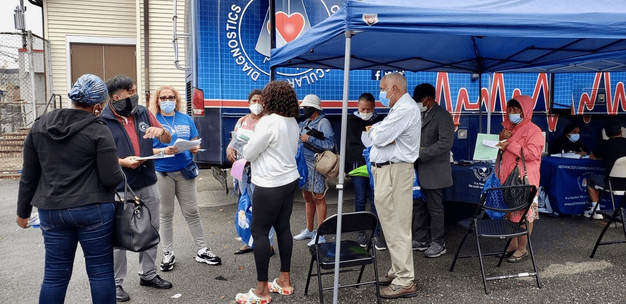 health and wellness pop-up event with participants getting information, giveaways with healthy foods for a Community Healthy and Safe