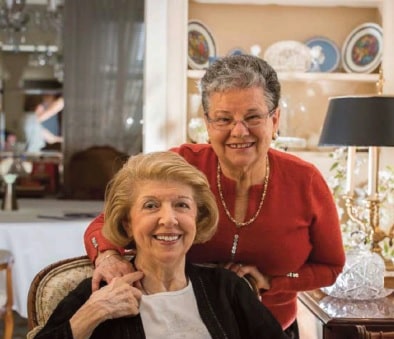 a volunteer is visiting a senior resident with the Southwest Queens Friendly Visiting Program