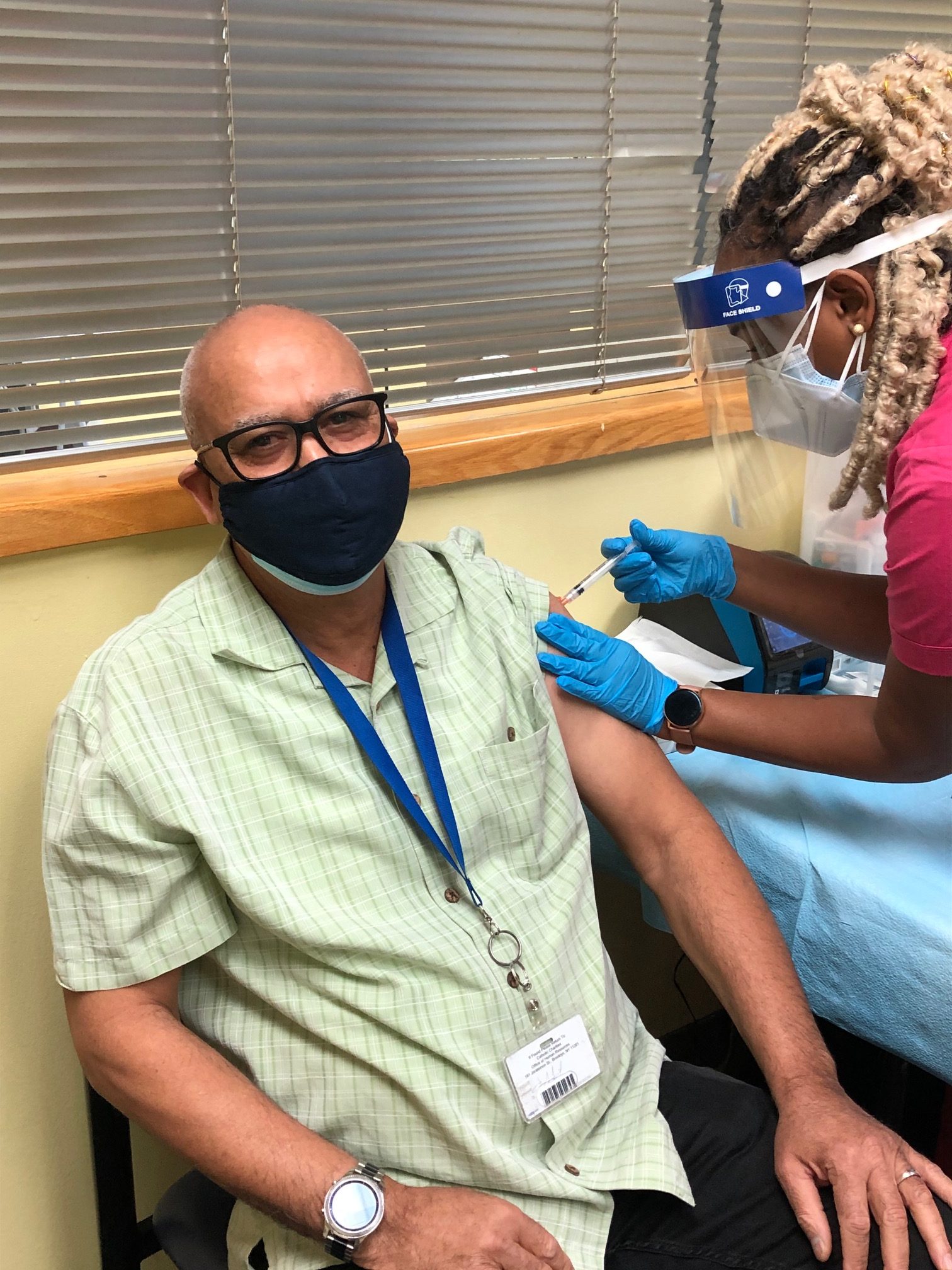 a man getting a vaccination shot during covid-19