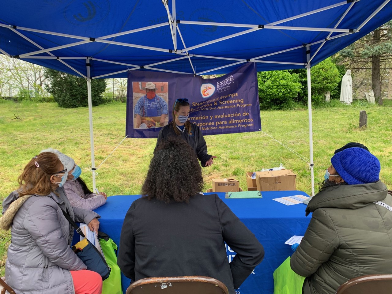 Gathering at a SNAP food stamps information and screening pop-up event