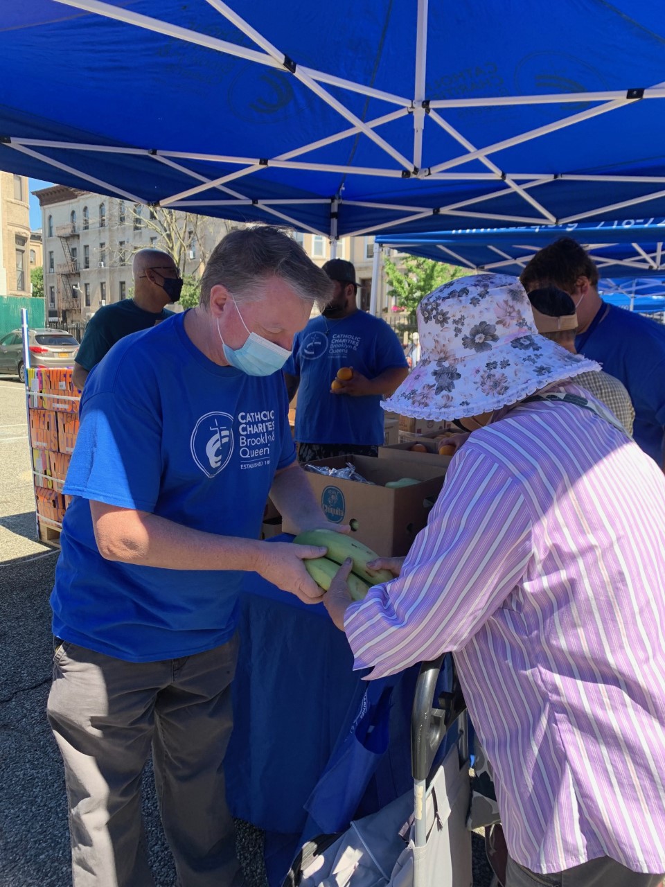 catholic charities of brooklyn and queens staff distributing food during a food bank event