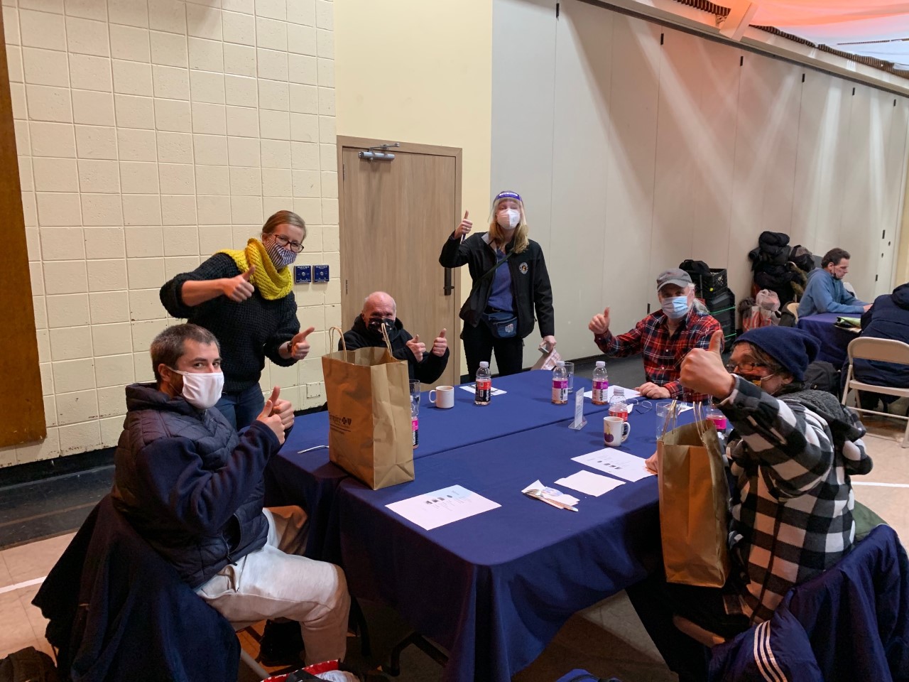 group of people with goody bags at a table