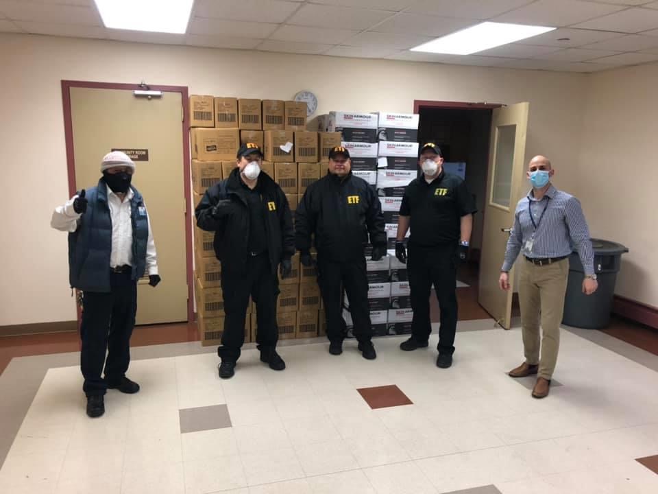 catholic charities staff with protective gear and supplies