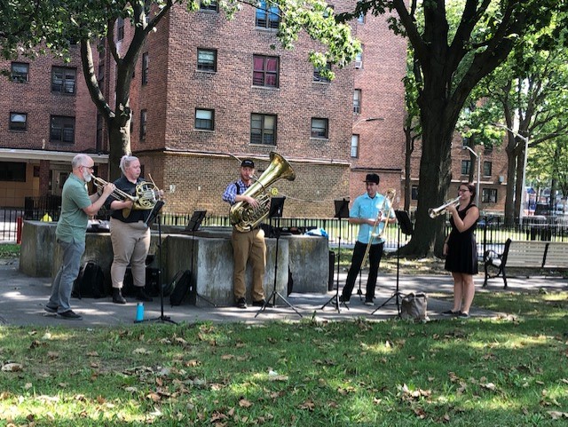 Orchestra performing in the backyard of The Bay Senior Center
