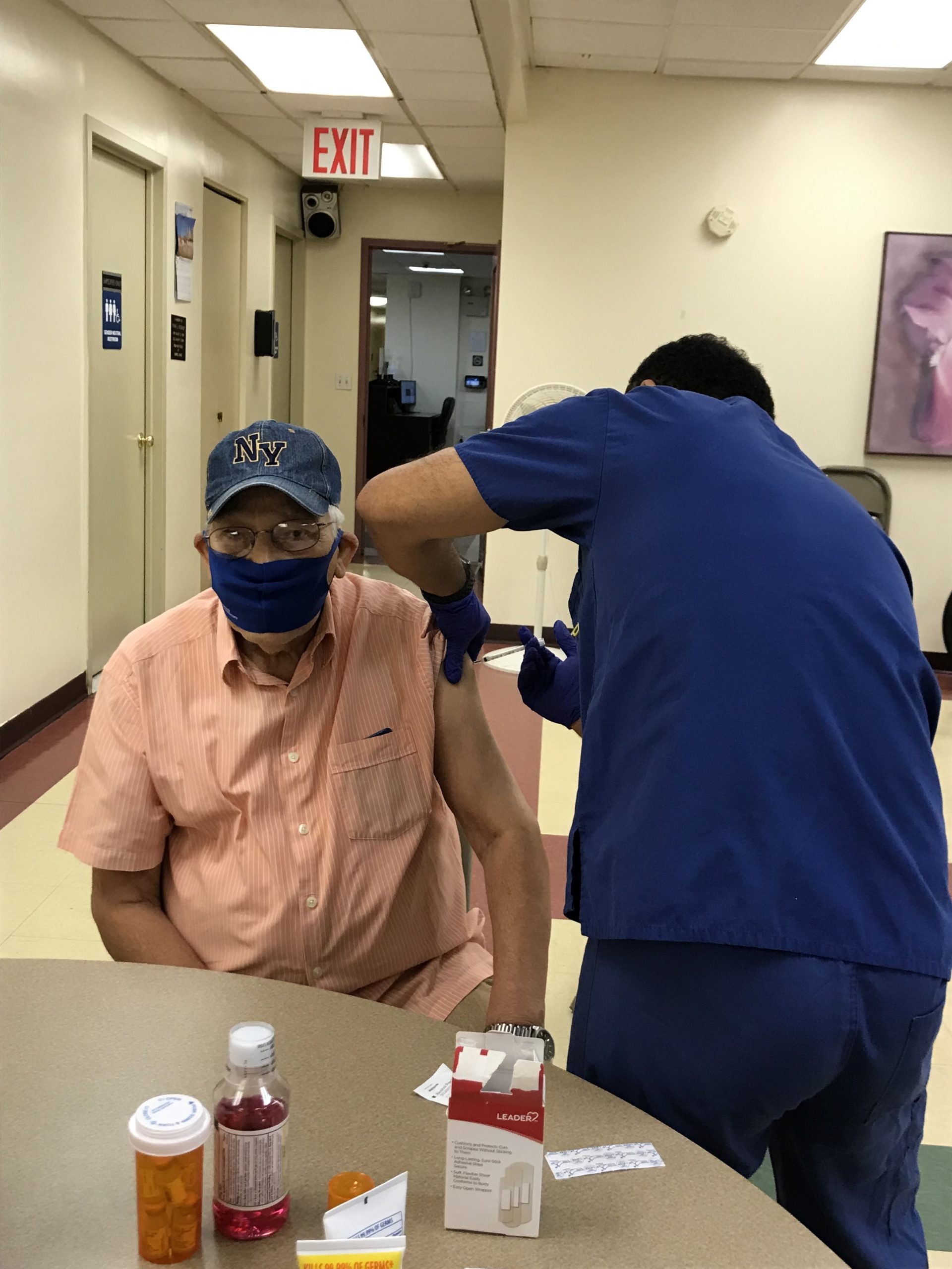Resident of Catholic Charities Msgr. Campbell Apartments receives flu shot.