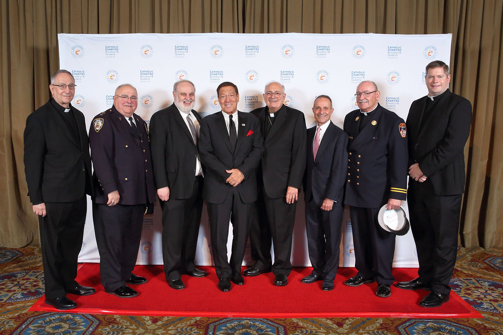 Alfred P. LoPinto, CEO and President of CCBQ, Honorees, Bishop DiMarzio, Bishop of Brooklyn and Fr. Patrick J. Keating, Deputy CEO of CCBQ at step and repeat at CCBQ's 2021 Bishop's Humanitarian Award Dinner.