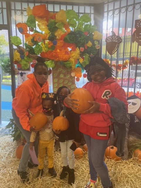 Catholic Charities Early Childhood Development Center families with pumpkins at pumpkin patch.