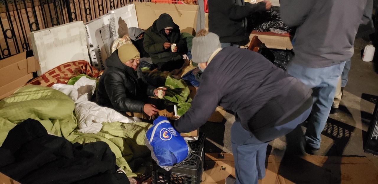Catholic Charities Brooklyn and Queens staff and volunteers distribute grab and go bags of food, basic necessities to homeless community.