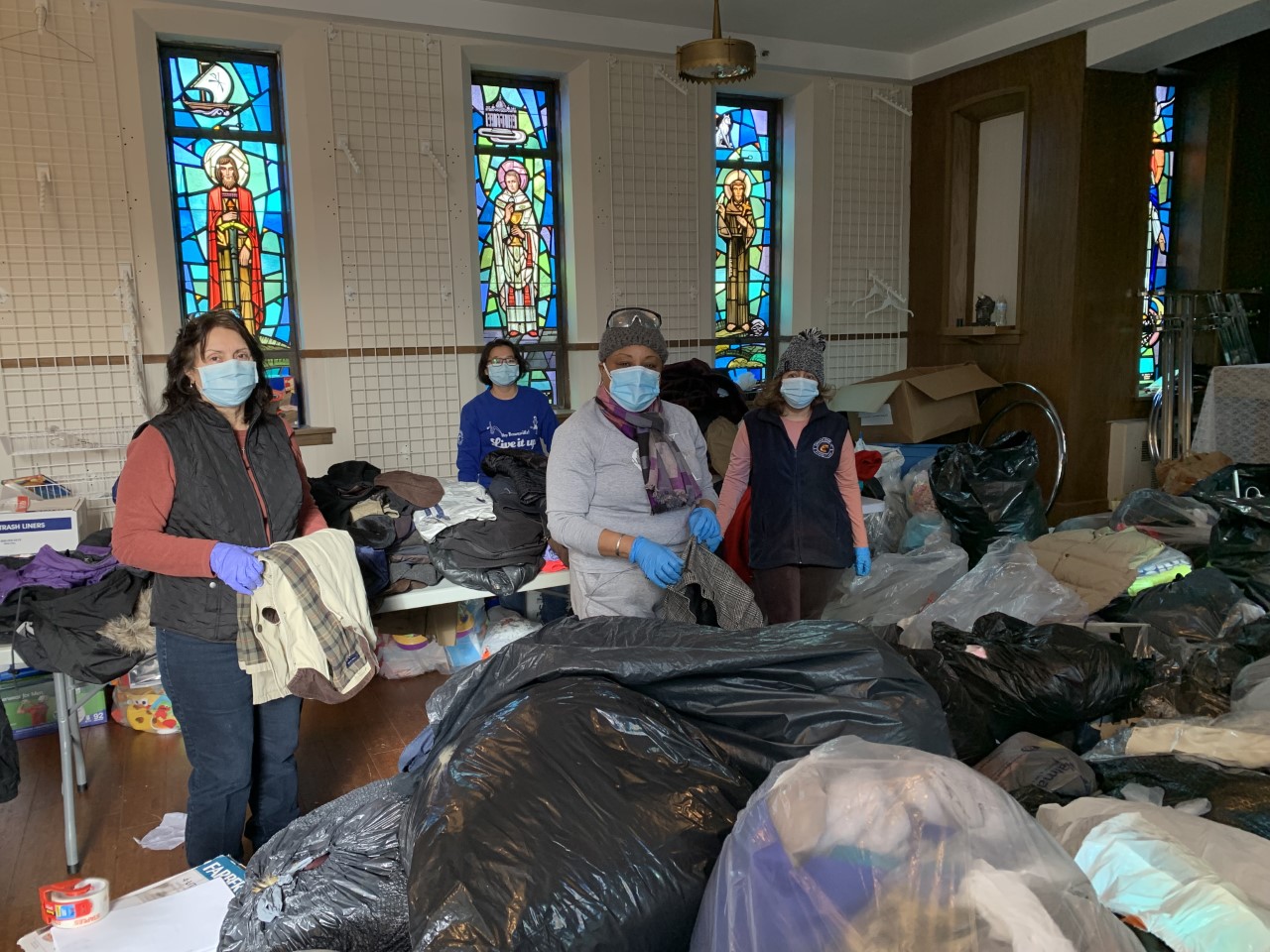 Catholic Charities staff and volunteers sort and organize donations for the homeless community, including coats, winter items and more.