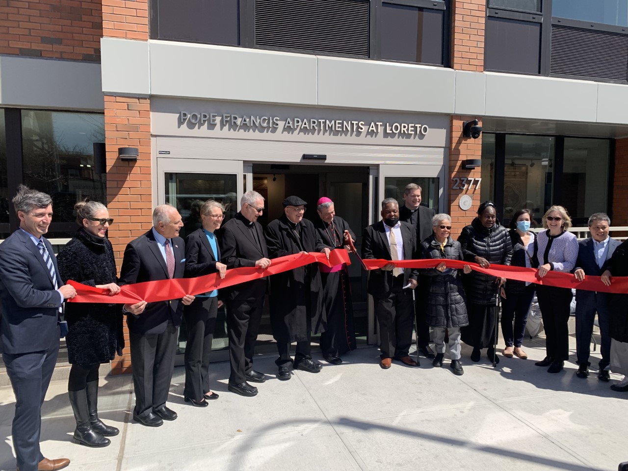 Group photo of the dedication and ribbon-cutting ceremony for the Pope Francis Apartments at Loreto taken on Thursday, April 28, 2022.