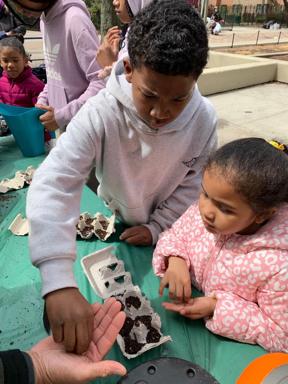 Our little ones plant seeds for a brighter future at our plant a seed interactive station.