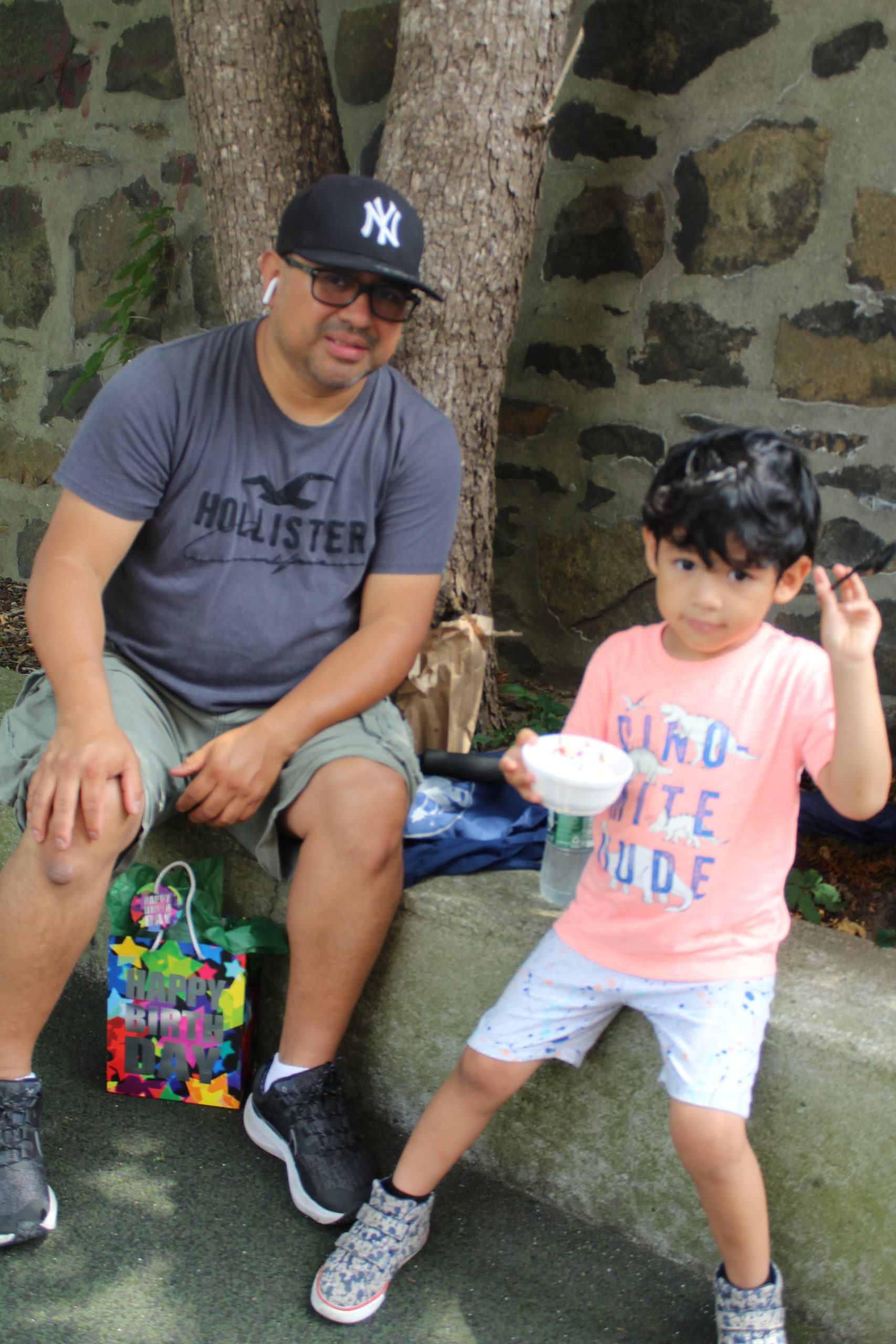 Parent and child bond while eating delicious ice cream at Ice Cream Social event.