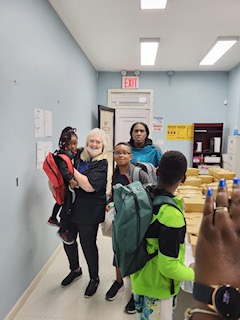 Catholic Charities Mobility Mentoring Program with recipient of backpack.