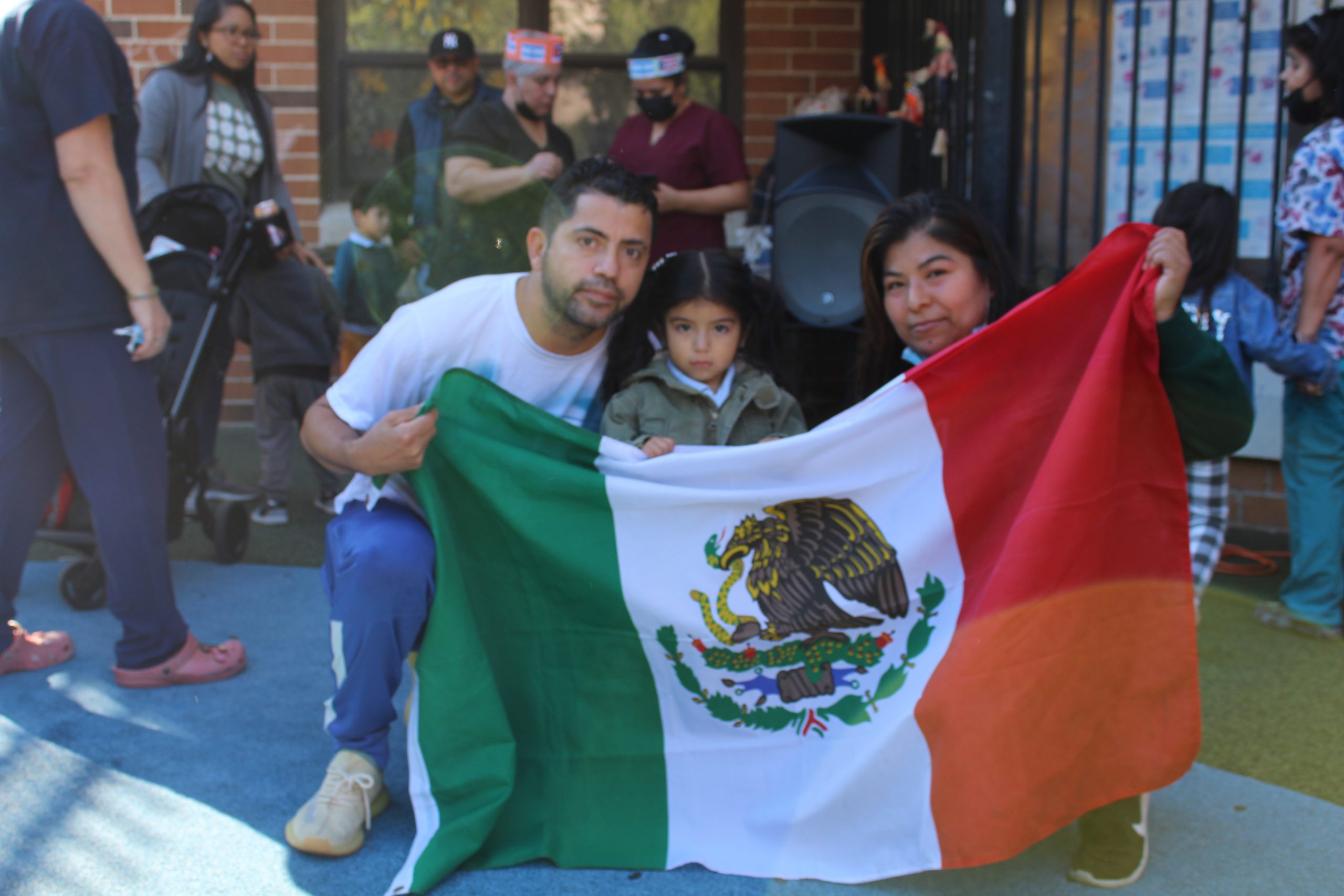 Family of center proudly displays their country's flag.