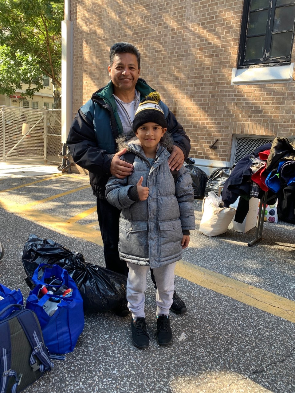 Refugee/asylee family with donated coat.