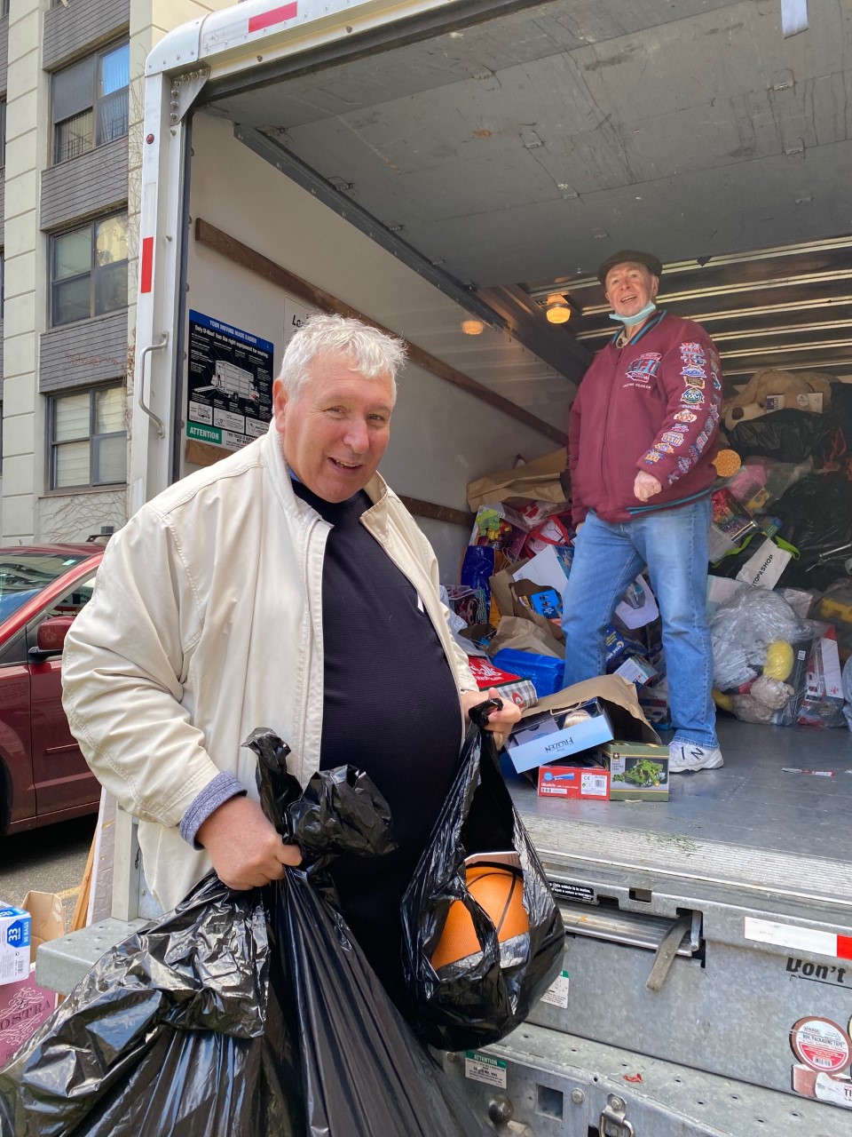Don Costello packs UHaul truck with donated toys for children in need