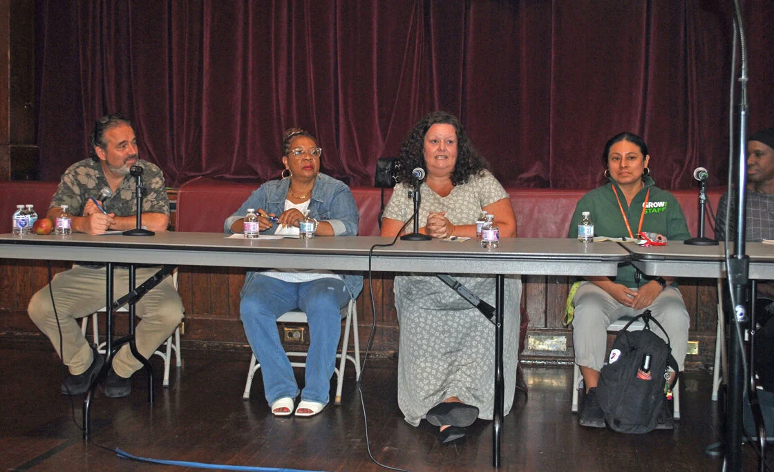 Group of people sitting at a table during a panel discussion about Food pantries dealing with post-Covid reality