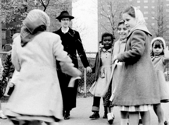 teacher and children playing outside in the 1950s