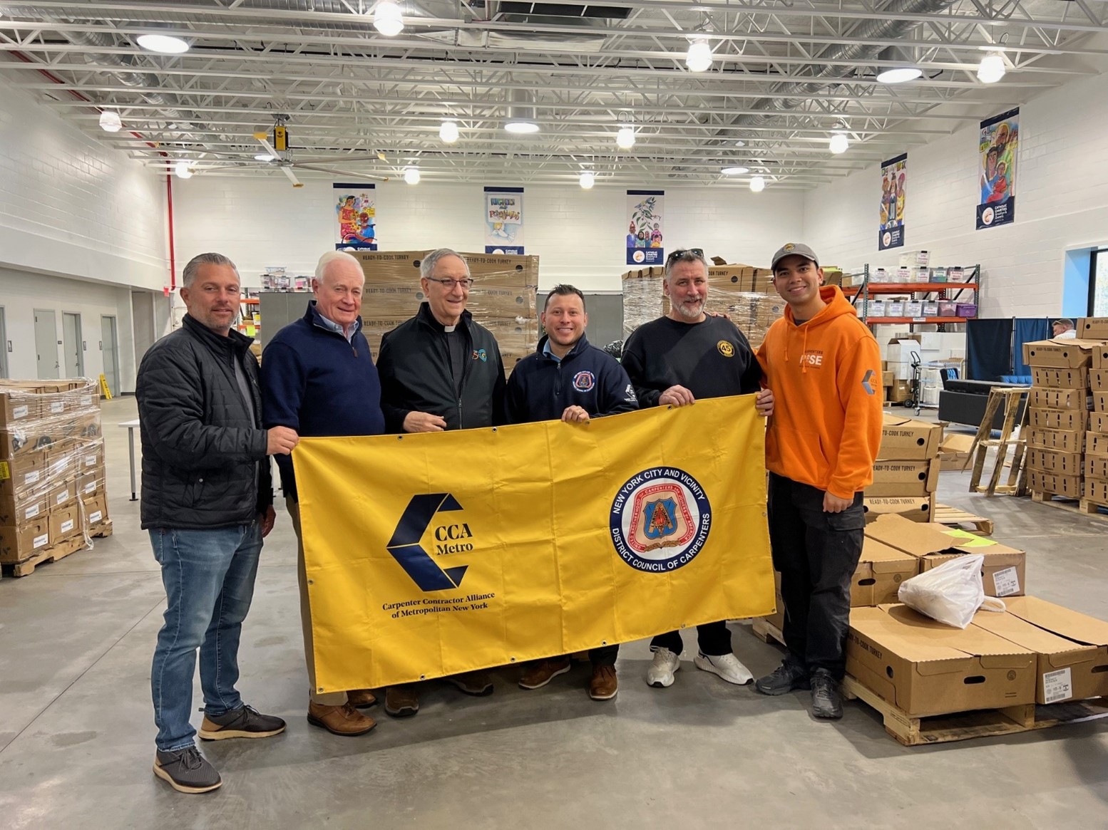 Members of the NYC District Council of Carpenters with Marty Golden, VP of Development, Catholic Charities Brooklyn and Queens (Second from the left), and Monsignor Alfred LoPinto, President and CEO of catholic Charities and Affiliated Agencies (Third from the left).