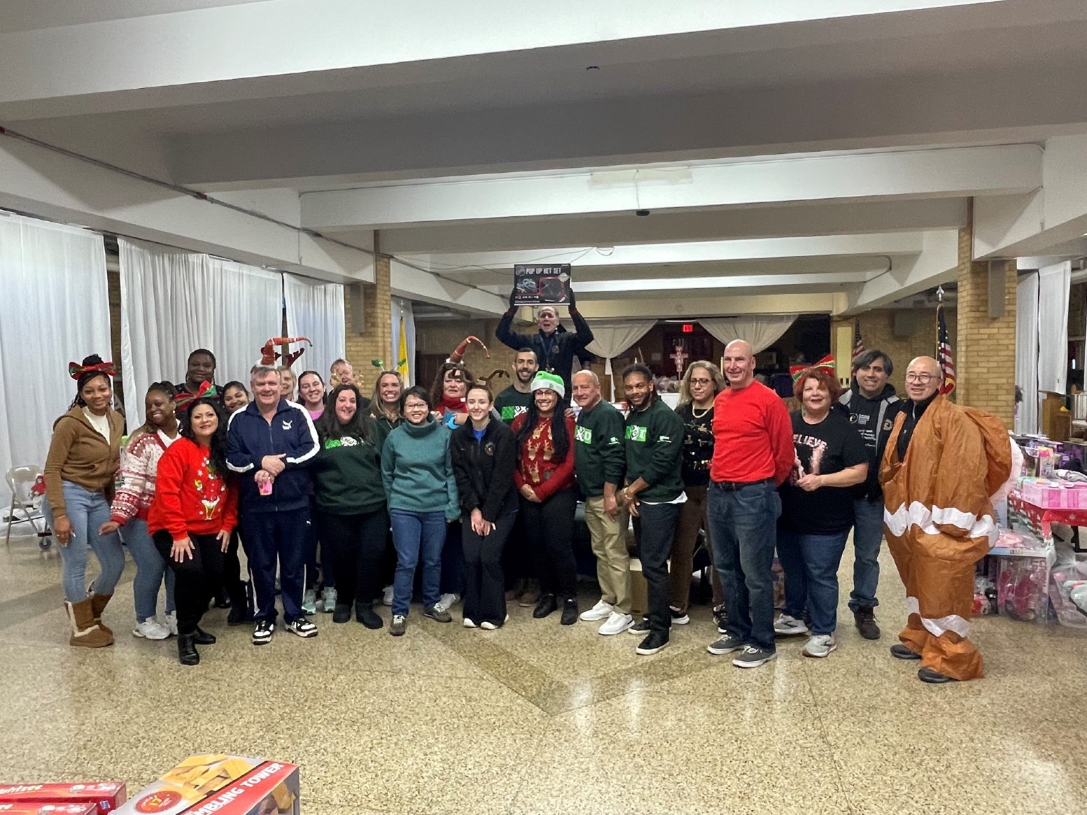 Volunteers and staff gather together at Saint Vincent Ferrer Roman Catholic Church in preparation for Santa’s Toy Shop.
