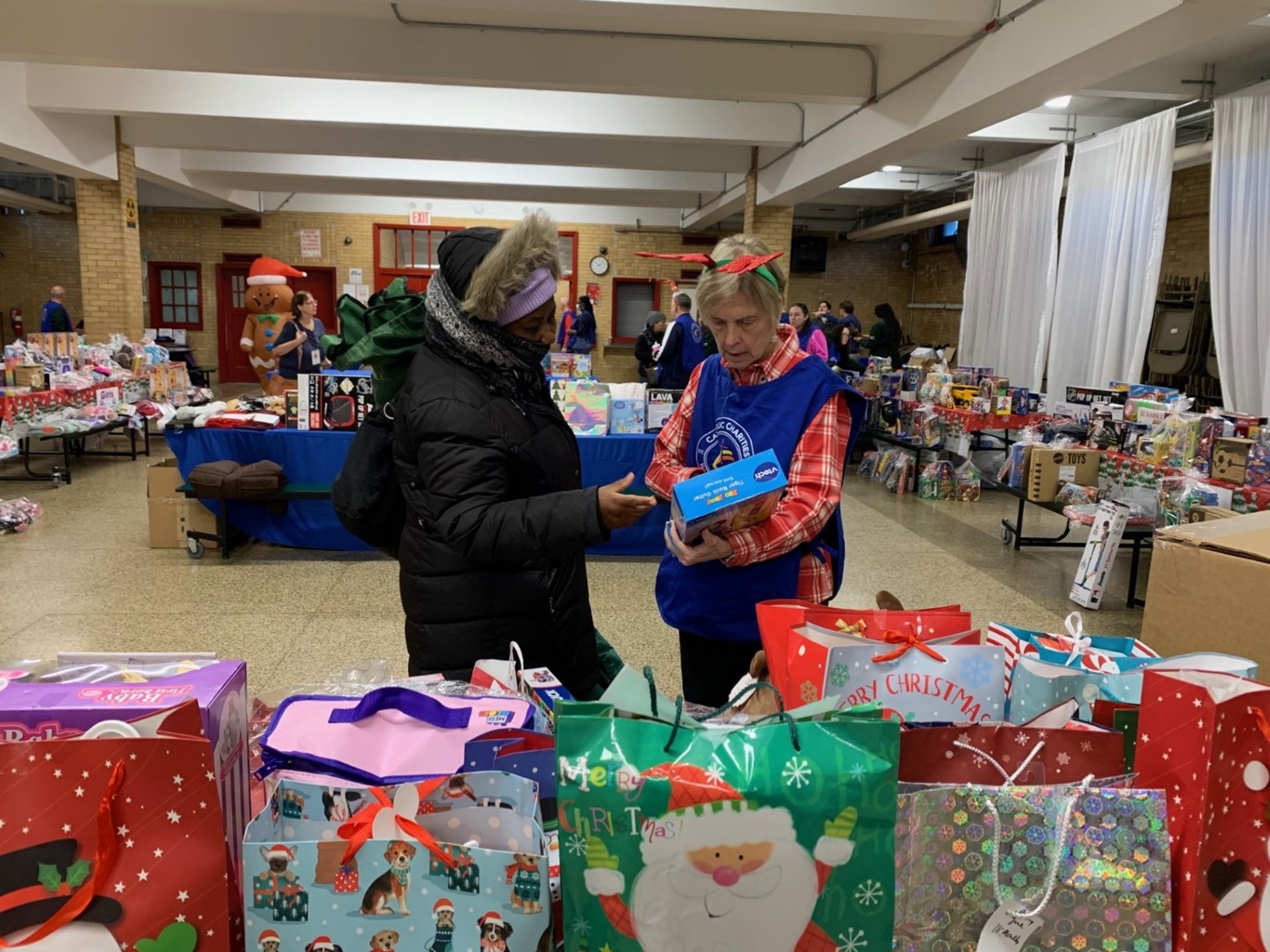Helper Elves could be seen all over Saint Vincent Ferrer Church helping parents through the Toy Shop.