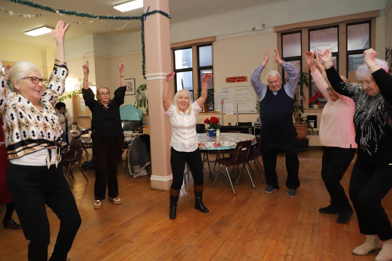 residents raising their hands while dancing at the carnival ball