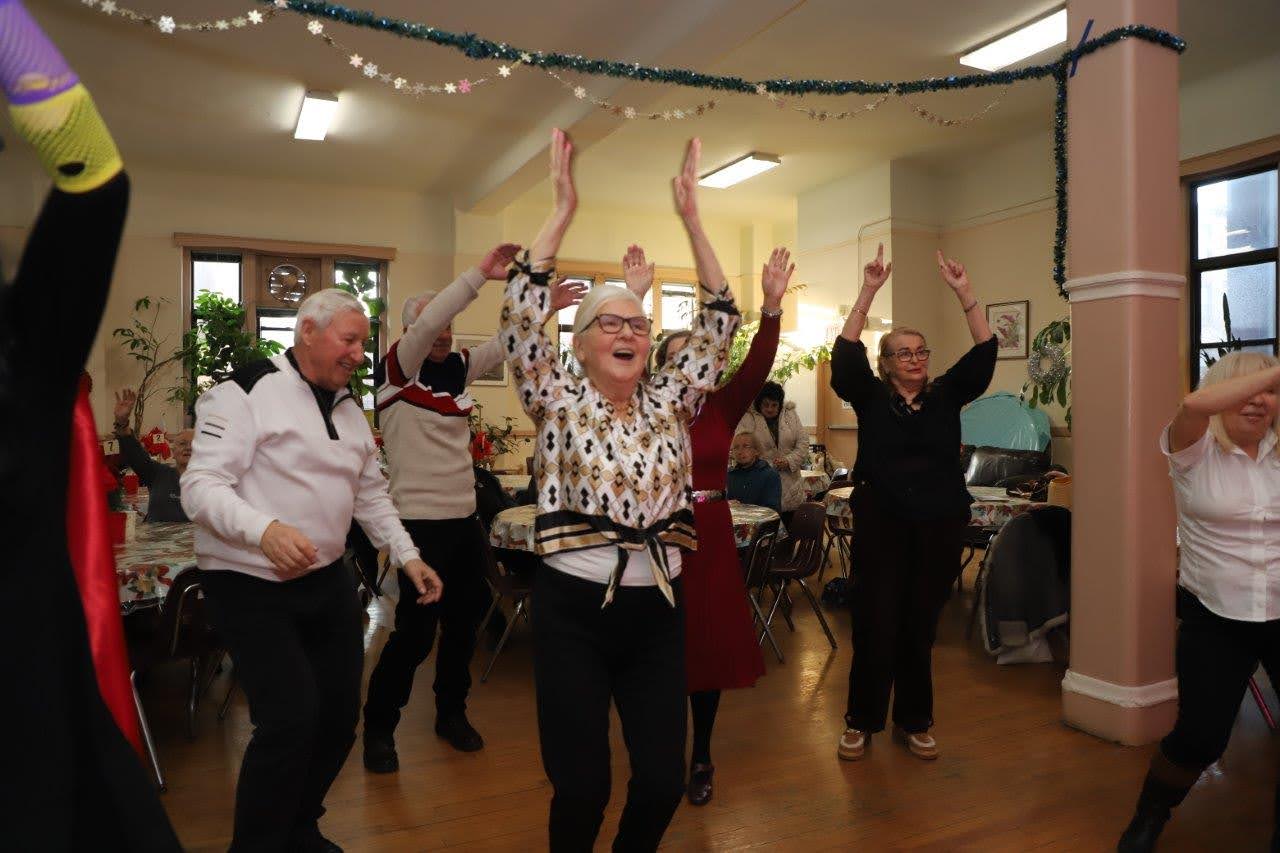 residents at pete mcguinness older adult center dancing and celebrating during the carnival ball