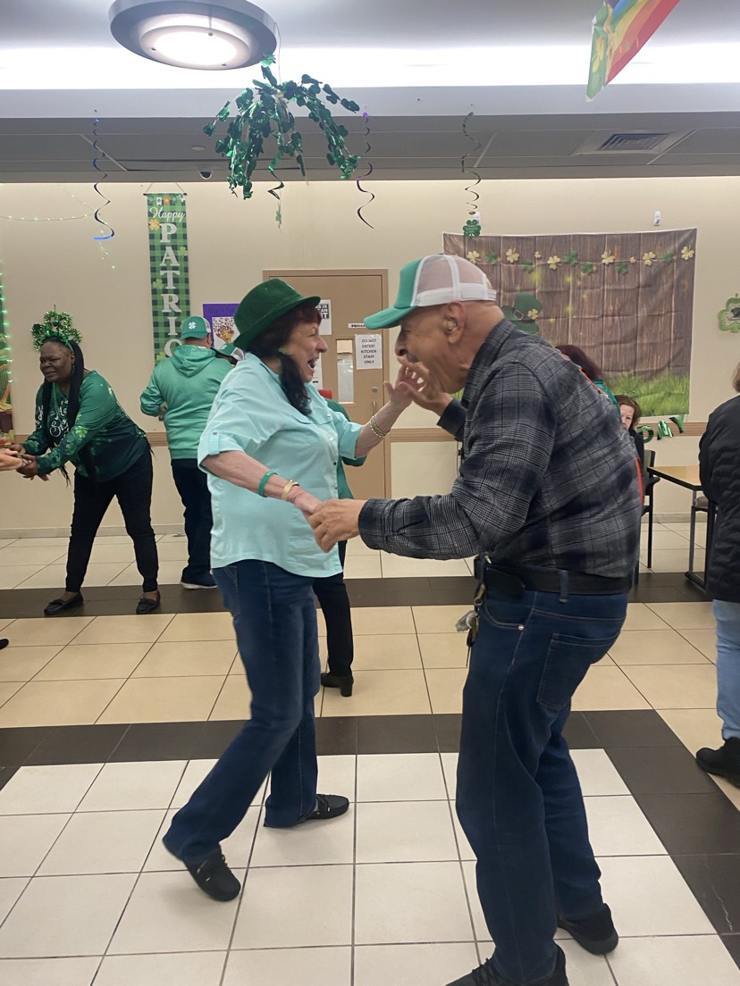 a couple dancing and celebratin saint patrick's day at howard beach older adult center